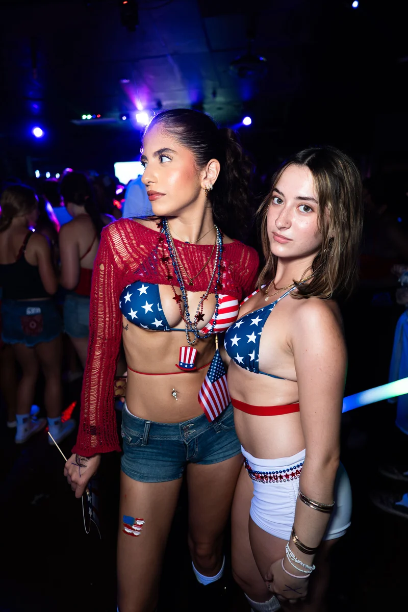 Guests in red, white, and blue outfits at a nightlife event